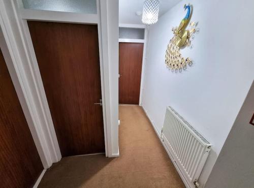 a hallway with a door leading to a room with a hallway at *F1*5GH* Setup for your most relaxed & amazing stay + Free Parking + Free Fast WiFi * in Leeds