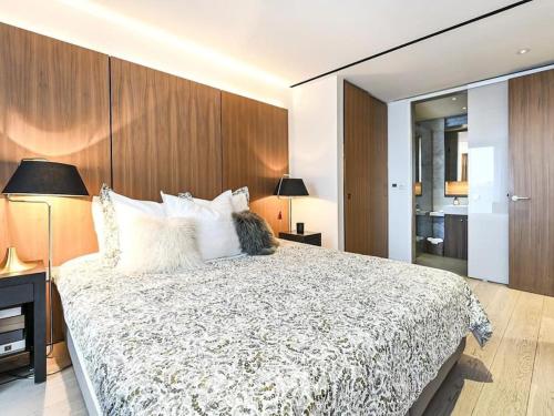 a bedroom with a large bed with white pillows at Soho - Mayfair Luxury Central Apartment in London