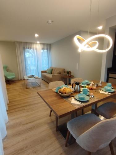 a living room with a table with chairs and a couch at Hotel Herzog Georg in Bad Liebenstein