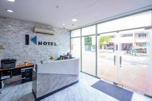 a kitchen with a hotel sign on a brick wall at K Hotel 12 in Singapore