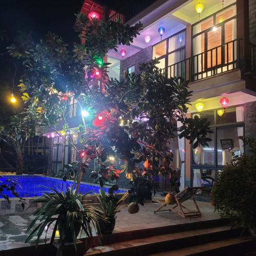 a building with a swimming pool at night at Tam Coc Mountain Lake Homestay in Ninh Binh