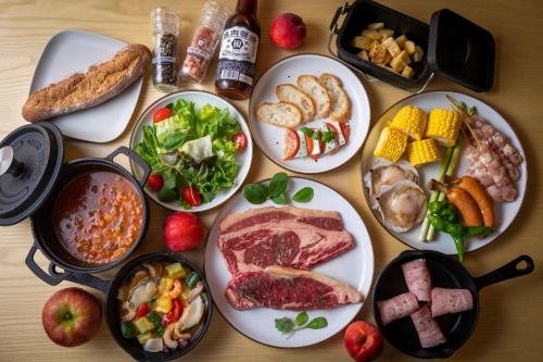 a table topped with plates of food with different types of food at mokki STARDUST GLAMPING in Achi