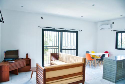 a living room with a couch and a table at RESIDENCE SAPHIR in Mahajanga