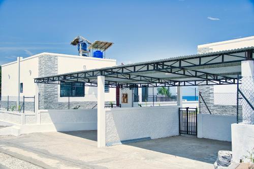 a metal pavilion in front of a building at RESIDENCE SAPHIR in Mahajanga