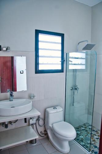 a bathroom with a toilet and a sink and a shower at RESIDENCE SAPHIR in Mahajanga