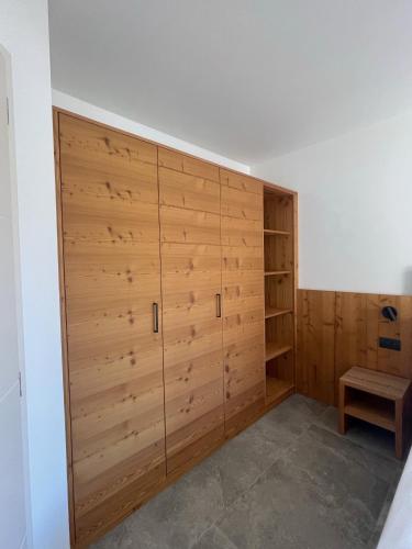 a large closet with wooden doors in a room at Al Marchior in Andalo