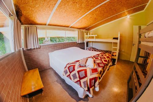a bedroom with a bed in a small room at Sítio Crescer in Garibaldi