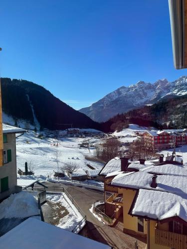 a town covered in snow with mountains in the background at Al Marchior in Andalo