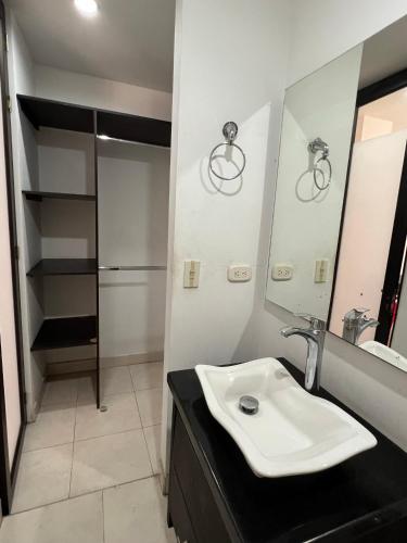 a bathroom with a sink and a mirror at Casa Raíces "Aire acondicionado, habitaciones familiares y económicas en La Dorada" in La Dorada