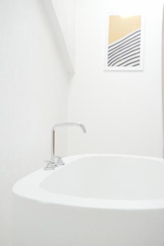 a sink in a bathroom with a white wall at Perle House in Fethiye