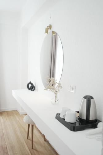 a white table with a mirror and a chair at Perle House in Fethiye