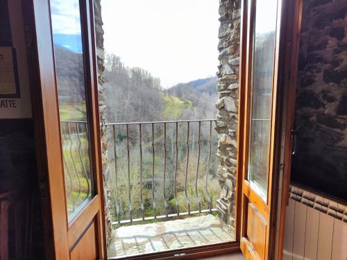 a window with a view of a mountain view at Allotjaments Cal Llarg in Molló