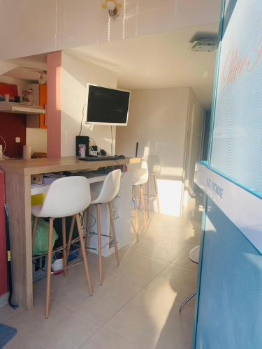 a room with a desk with chairs and a computer monitor at Hostel OT in Split