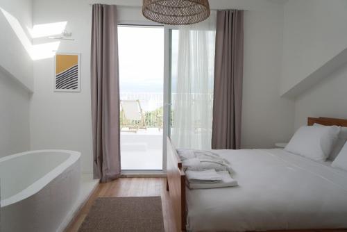 a bedroom with a bath tub and a bed and a bath tub at Perle House in Fethiye