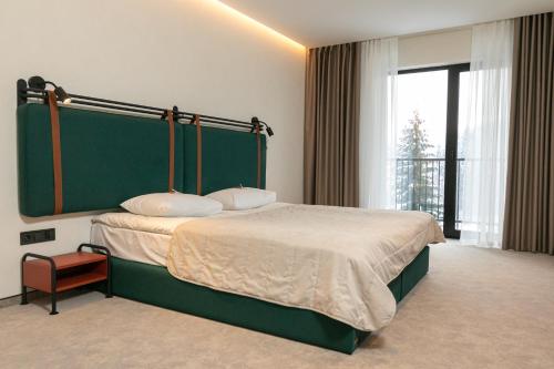 Postel nebo postele na pokoji v ubytování HVOYA Apart-Hotel & SPA