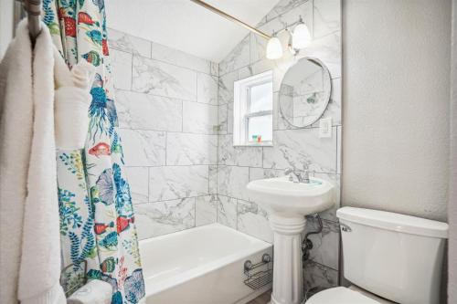 a bathroom with a sink and a toilet and a shower curtain at C2-Seahorse in St. Pete Beach