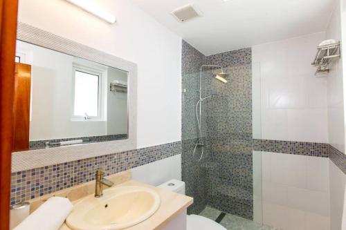 a bathroom with a sink and a shower at Ocean Views & Private Beach! Luxury 4BDR Getaway in Punta Cana