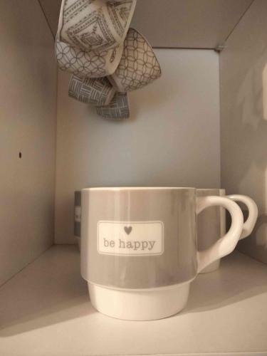 a coffee cup with the words be happy on it at La Rovettina in Verolanuova