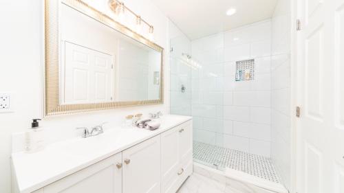 a white bathroom with a sink and a shower at LA Retreat in Los Angeles