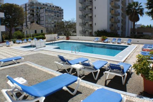 a swimming pool with lounge chairs and a swimming pool at Casa Branca Apartments by Wanderlust Madeira, vacation rentals in Funchal