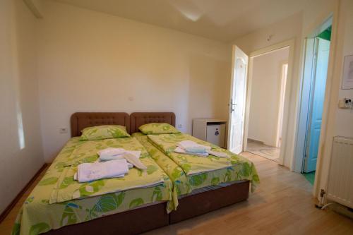 a bedroom with a bed with towels on it at Villa In Apartments in Ohrid