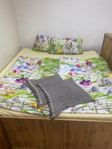 a bed with two blankets and pillows on it at Aparmánový byt v centre Banskej Bystrice & free parking in Banská Bystrica