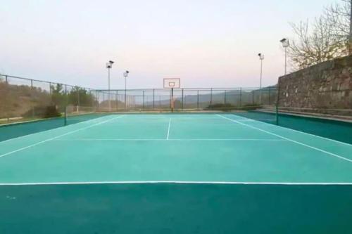 a tennis court with a basketball hoop on it at Villa Oğuz in Milas