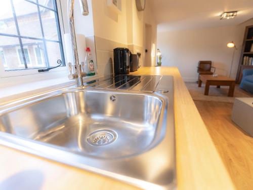 a stainless steel kitchen sink in a kitchen at The Annexe in Wisley