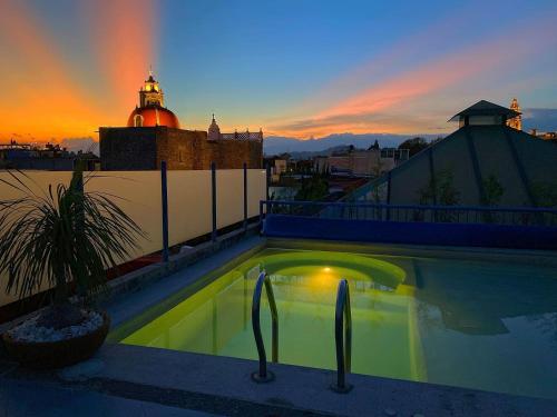 a swimming pool on the roof of a building at Estrella de Belem B&B and Spa in Cholula