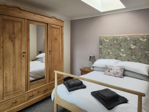 sypialnia z 2 łóżkami i dużym lustrem w obiekcie East Lodge w mieście Kingholm Quay