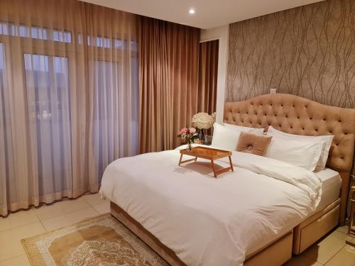 Un dormitorio con una cama grande y una mesa. en Amazing Villa in Muscat, en Seeb
