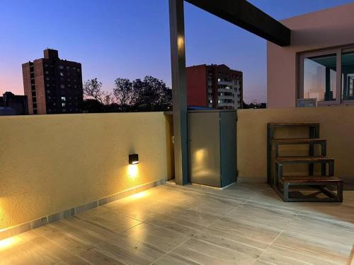a room with a balcony with a view of a city at LUMINOSO piso con jacuzzi in Alta Gracia