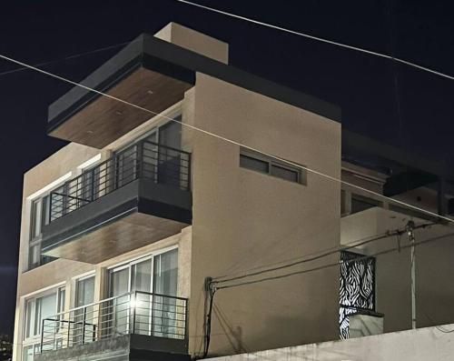 a building with balconies on the side of it at LUMINOSO piso con jacuzzi in Alta Gracia
