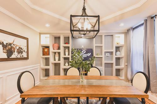 a dining room with a table and chairs and a chandelier at Chic & Cozy City Living Enjoy Baltimore in Style in Baltimore