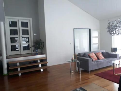 uma sala de estar com um sofá e uma mesa em Rum i fint villa nära centrum em Jönköping