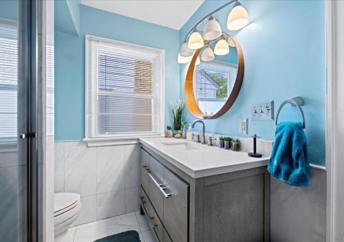 a bathroom with a sink and a mirror at Charming 3 Bedroom House in a Quiet Neighborhood in Columbus