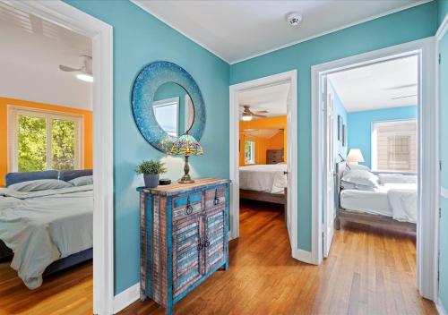 a bedroom with blue walls and a mirror at Charming 3 Bedroom House in a Quiet Neighborhood in Columbus