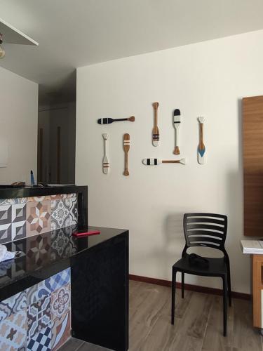 a room with a chair and somerenches on the wall at Casa em Barra Grande com piscina in Marau