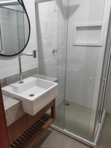 a bathroom with a sink and a shower at Casa em Barra Grande com piscina in Marau