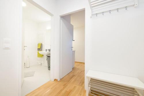 a white apartment with white walls and wood floors at Premium City Apartment with balcony! Free Garage Parking included! in Vienna