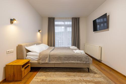 a bedroom with a bed and a window at GARDA - Breakfast included in the price Restaurant Free Parking Mountain view Kitchen in the apartment separate entrance in Bukovel