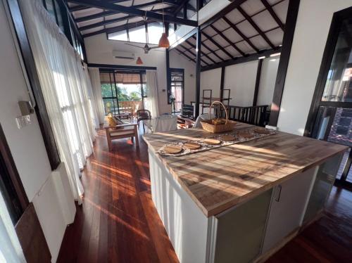 a kitchen with a counter top in a room at Gaze: Entire Modern Tropical Seaview Villa in Pantai Cenang