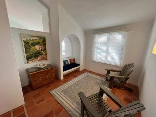 a living room with two chairs and a table at OceanBlue Resort in Christ Church