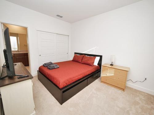 a bedroom with a bed and a desk and a television at Luxury 3 Bedroom House Near Sacramento Airport in Sacramento