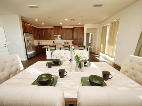 a dining room and kitchen with a table and chairs at Luxury 3 Bedroom House Near Sacramento Airport in Sacramento