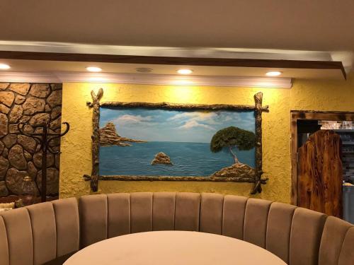a painting of the ocean on a wall at ÇARŞI HOTEL&CAFE in Trabzon