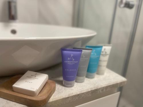 a bathroom with three products on a shelf next to a sink at ONLY ONE Suites & Residences in Antalya