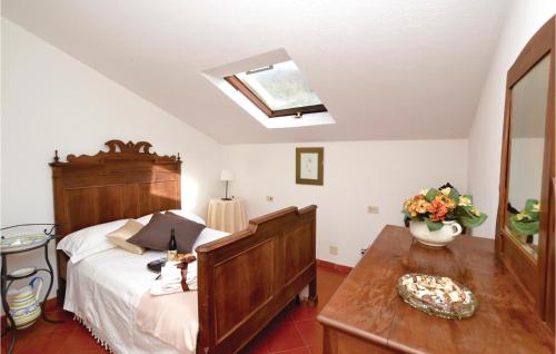 a bedroom with a bed and a table and a skylight at Casa Lià in San Biagio