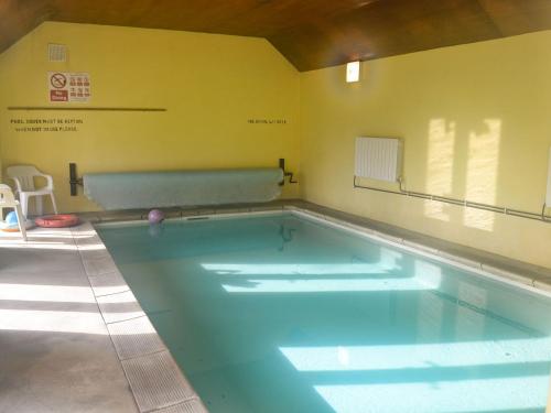 a large swimming pool in a room at Copper Beech in Netherbury