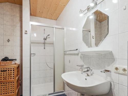 a white bathroom with a sink and a shower at Igl Hof Top 4 in Westendorf
